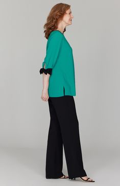 A perfectly simple blouse with beautiful tie cuffs. Always trimmed in black so it pairs easily with your favorite black pant. Featuring ¾ sleeves and a back neckline keyhole. Chic Blouse With 3/4 Roll-up Sleeves, Chic Blouse With Roll-up 3/4 Sleeves, Chic 3/4 Sleeve Blouse With Button Cuffs, Formal Black 3/4 Sleeve Top, Formal Black Top With 3/4 Sleeves, Elegant 3/4 Sleeve Blouse With Button Cuffs, Elegant Formal Blouse With 3/4 Sleeves, Elegant Blouse With 3/4 Sleeves And Button Cuffs, Chic Half Sleeve Formal Blouse