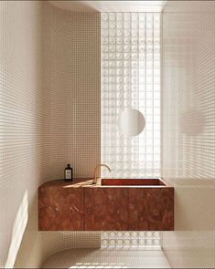 a bath room with a sink and a mirror on the wall next to a window