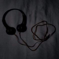 a pair of headphones sitting on top of a bed