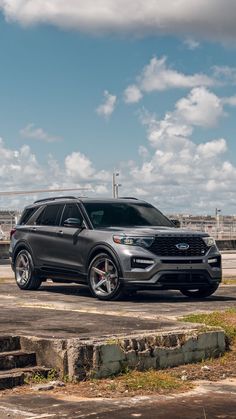 the new ford explorer is parked in an empty lot