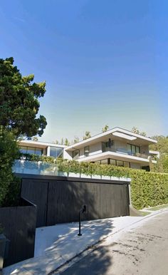 the house is surrounded by trees and bushes