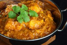 a pot filled with curry and topped with cilantro