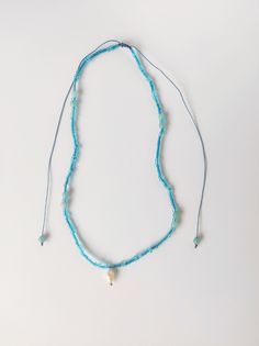 Light blue necklace with a hanging pearl on a blue waxed cord.  Made from blue glassbeads, freshwater pearl, aquamarine gemstones and waxed cord. At the ends of the cord aquamarines are added. Necklace has a sliding knot. Wax cord is adjustable, length up to 64 cm. It can be cut for shorter cords. Each jewelry piece comes in Snasty branded packaging and personalised message printed on a typewriter. Let me know while ordering which message you would like to have printed or it can be a surprise! Light Blue Necklace, Princess Necklace, Gold Work, Sliding Knot, Aqua Marine, Branded Packaging, Aquamarine Gemstone, Blue Necklace, Jewelry Pieces