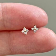 These tiny dainty flower stud earrings are made from 14k real solid gold.  ★ These earrings sold as a pair with push backs. 1 pair of 14k solid gold with silicone backs and 1 pair 14k gold vermeil backs.  ♡ Features  * Gold Kt: 14K solid gold * Available Gold Color: Yellow Gold * Number of Stones: 4 * Gemstone: Cubic Zirconia * Stone Color: Flawless D Color * Stone Cut: Round Cut * Measurement: 3mm*3mm * Length of earring post: 10mm * Stamped with 14K(Au585) hallmark  ♡ Shipping & Returns Orders Dainty White Diamond Earrings, 14k Gold Diamond Flower-shaped Earrings As Gift, 14k Gold Flower-shaped Diamond Earrings As Gift, 14k Gold Diamond Flower Earrings For Gift, Dainty 14k Gold Flower Earrings, 14k Gold Diamond Flower Earrings As Gift, Dainty 14k Yellow Gold Flower Earrings, Dainty Yellow Gold Flower Earrings, Dainty 14k Gold Flower Earrings For Anniversary