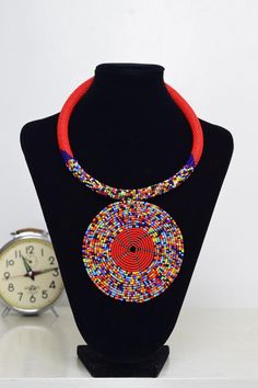 Unique African Maasai Handcrafted Beaded Necklace with an Elegant Look and Brilliant Finish.Color - Red and Mixed Color Beads.Length (Around Neck) - 17 Inches/ 43.2 Centimeters. Length (Downwards)  - 4.5 Inches / 12 Centimeters.**GET FREE SHIPPING FOR ADDITIONAL ITEMS PURCHASED.Yes, Buy Multiple Items and pay shipping for 1 item only- The rest ships Free. (No Limits on the number of Multiple items). With a faster delivery time of 3 days via DHLExpress, Worldwide. Ordinary/Standard Shipping also Bohemian Red Necklace With Black Beads, Artisan Red Beaded Necklace With Round Beads, Artisan Red Jewelry With Black Beads, Artisan Red Beaded Necklace, Red Round Beads Choker For Festivals, Traditional Red Necklace With Black Beads, Bohemian Red Choker With Colorful Beads, Traditional Red Necklaces With Black Beads, Red Bohemian Choker With Colorful Beads