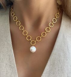 Indulge in the luxurious elegance of our Oceanside Baroque Pearl Necklace. The 18k gold plated circular design accentuates the natural beauty of the baroque pearl, making it a unique and sophisticated addition to any outfit. Elevate your style and make a statement with this stunning necklace. Materials: Baroque Pearl & 18K Gold Plated Chain. Length: 16" plus 2" extension Handmade in Vero Beach, FL USA Elegant Gold Beaded Baroque Pearl Necklaces, Luxury Elegant Baroque Pearl Beaded Necklaces, Luxury Baroque Pearl Necklace, Luxury Beaded Baroque Pearl Necklaces, Luxury Baroque Pearl Drop Beaded Necklace, Baroque Pearl Necklace, Stunning Necklace, Gold Plated Chains, Baroque Pearls