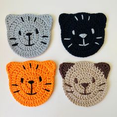 three crocheted coasters with cats on them