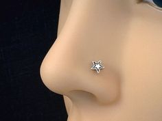 a close up view of a nose with a small star on it