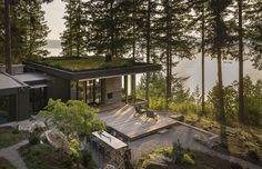 the house is surrounded by trees and water