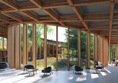 the inside of a building with lots of windows and people sitting at tables in it