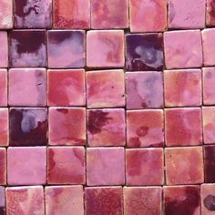 a close up view of some pink and purple tiles