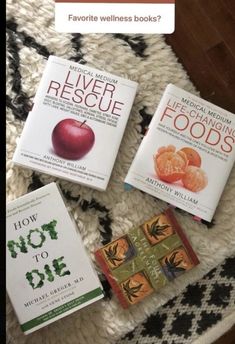 three books sitting on top of a rug next to each other