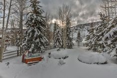 a hot tub surrounded by snow covered trees