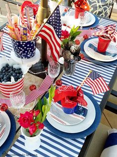 a patriotic table setting with red, white and blue decorations