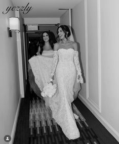 two brides are walking down the hallway together