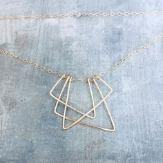 Geometirc art deco pendant gold triangle necklace | Etsy Modern Gold Geometric Necklace, Gold Triangle Brass Jewelry, Handmade Geometric Gold Jewelry, Modern 14k Gold-filled Necklaces, Modern 14k Gold Filled Necklaces, Modern 14k Gold Filled Gold Necklace, Modern Gold Wire Wrapped Jewelry, Geometric 14k Gold Jewelry, 14k Gold Triangle Shaped Jewelry