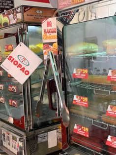 a display case in a store filled with donuts and other food items for sale