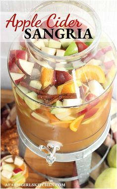 an apple cider sangria with apples, oranges and other fruit in it