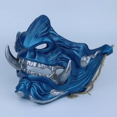 Carefully sculpted to resemble an Oni a fearsome demon mask originating from Japanese folklore our Oni Demon Japanese Mask is ideal for cosplay enthusiasts, venturing into the mysterious world of samurai. Details: We have padded the inside of the mask for your facial comfort. The mask can stay on your face for a long time in the activity you use. It does not cause pain on your face and you can breathe comfortably. It is very robust in your activities with its high filling and extra layer thickne Warrior Style Masks For Cosplay And Masquerade Events, Warrior Style Masks And Prosthetics For Halloween, Warrior Masks And Prosthetics For Halloween, Warrior Style Halloween Costume Masks And Prosthetics, Halloween Warrior Costume Masks And Prosthetics, Traditional Cosplay Masks And Prosthetics, Traditional Cosplay Masks, Blue Fantasy Costume Accessories For Cosplay, Warrior Style Masquerade Mask For Halloween