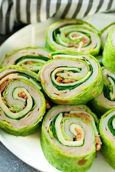 there are many green rolls on the plate