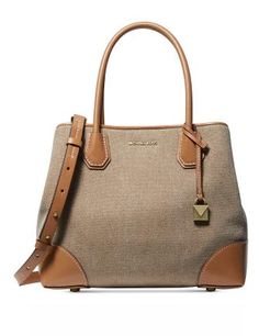 An easygoing canvas silhouette gets accented with luxe leather corners and trim on the take-anywhere MICHAEL Michael Kors Mercer Gallery Canvas Center Zip Tote.Medium sized ; 13"W x 10"H x 5-1/2"D (width is measured across the bottom of handbag)6-1/2"L handles; 17"L to 20"L removable strapSnap top closureGleaming exterior hardware1 interior zip compartment, 1 back zip pocket, 1 back slip pocket & 4 front slip pocketsCanvas fabric (cotton); trim: leather; lining: polyesterColor: Natural Canvas Satchel, Silhouette Canvas, Michael Kors Mercer, Michael Kors Satchel, Leather Duffle, Natural Gold, Zip Tote, Purse Accessories, Handbags Michael Kors