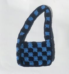 "This hand-crocheted shoulder bag features a blue and navy checkered print throughout the entire bag. Made in Canada. Measurements: 8\" x 6 x 2\"" Blue Square Shoulder Bag For School, Trendy Blue Crochet Bags, Trendy Navy Rectangular Shoulder Bag, Casual Gingham Square Shoulder Bag, Blue Crochet Bag With Granny Square For Everyday, Trendy Blue Crochet Bag For Everyday, Trendy Blue Crochet Bag For Everyday Use, Blue Square Crochet Bags, Blue Rectangular Crochet Bag