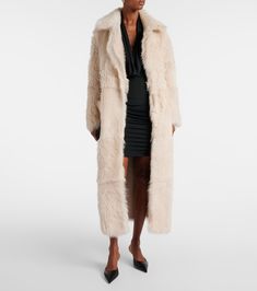 Evita shearling coat in neutrals - Nour Hammour | Mytheresa Luxury Cream Fur Coat With Faux Fur Lining, Elegant Long Shearling Coat, Chic Sheepskin Fur Coat With Faux Fur Lining, Chic Sheepskin Coat With Faux Fur Lining, Mink Sheepskin Long Coat, Mink Color Sheepskin Long Coat, Long Sheepskin Coat In Mink Color, Sheepskin Long Coat In Mink Color, Luxury Beige Sheepskin Fur Coat