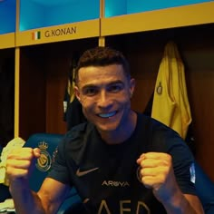 a man with his fist up in the locker room