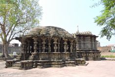 an old stone structure in the middle of a park