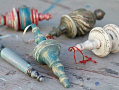 three old, broken and rusty metal objects are on the ground next to each other