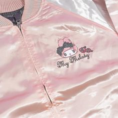 This super cute jacket is inspired by the iconic “sukajan” or the Japanese baseball varsity jacket that’s known for its large back design! Wear this shiny pink and white bomber jacket to keep you warm when it’s rainy! It has long sleeves, a small My Melody embroidery at the front, and a bigger version at the back! Made from 100% satin-like polyester Comes with a zipper closure and side pockets Width: 58 cm Length: 67 cm Sleeve length: 85 cm Trendy Varsity Jacket With Baseball Collar For Spring, Trendy Varsity Jacket With Baseball Collar, Trendy Varsity Jacket With Zipper For Streetwear, Trendy Hooded Varsity Jacket For Spring, Kawaii Style Outerwear For Fall Streetwear, Sporty Pink Varsity Jacket For Spring, Trendy Long Sleeve Varsity Jacket With Zipper Closure, Kawaii Outerwear For Fall Streetwear, Trendy Pink Varsity Jacket For Spring