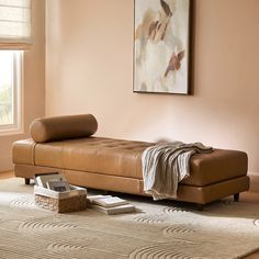 a living room with a couch, rug and painting on the wall in it's corner