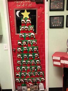 a christmas tree made out of pictures on a door with santa's hats hanging from it