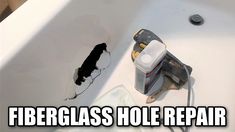 a bathroom sink with a hole in the wall next to it that has been repaired