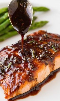 the salmon is being drizzled with bbq sauce on it's side