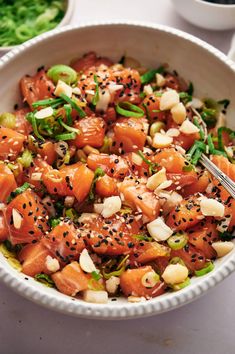 a white bowl filled with salmon and vegetables