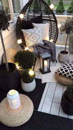 a porch decorated with potted plants and lights