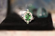 Gorgeous LARGE Green Tsavorite Garnets set in a stunning art deco style setting. This ring has all that glam and drama with the vibrant greens glowing off the high polished silver. There are two small Tsavorite Garnets that sit top and bottom of this ring. If you love rings with drama and color then this is definitely for you, the emerald greens from the natural Tsavorite will spark inspiration and pure joy. Its an all around BOMBSHELL of a ring.This ring is set in a size 8.Tsavorite Garnet: Cla Heirloom Style Green Emerald Ring With Polished Finish, Heirloom Style Polished Emerald Ring, Unique Green Emerald Ring For Formal Occasions, Polished Emerald Ring For Wedding, Classic Emerald Ring With Tsavorite Accent Stones, Art Deco Round Green Emerald Ring, Elegant Peridot Emerald Promise Ring, Art Deco Green Oval Emerald Ring, Elegant Tsavorite Rings With Polished Finish