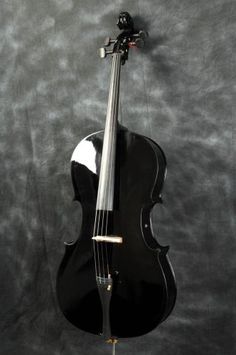 a black violin on display against a gray background