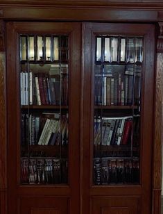 a wooden book case filled with lots of books