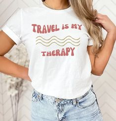 Travel Is my Therapy Shirt, Retro Travel Shirt, Vacation Shirt, Wanderlust Shirt, Funny Travel Shirt, Travel Shirt, Gift For Traveler Need a new and trendy t-shirt for your next vacay? You've come to the right place!  -SIZING  I recommend using the size chart provided to ensure you are getting the best, most accurate fit for you. For an oversized look, please size up 1-2 sizes. -MATERIAL Solid colors: 100% Airlume combed & ringspun cotton Retail fit Shoulder taping Sideseamed Tearaway label Pre- Graphic Tee With Letter Print For Travel, White Letter Print Top For Travel, White Summer Travel Tops, White Crew Neck T-shirt For Travel, Cotton Travel Tops With Letter Print, Cotton Letter Print Travel Tops, White Summer Tops For Travel, Cotton Letter Print Tops For Travel, White Tops For Summer Travel