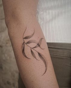 a woman's arm with a tattoo design on the left side of her arm