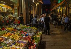 an outdoor market with lots of fruits and vegetables