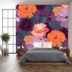 a bed room with a neatly made bed and a flower wall mural on the wall