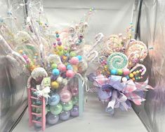 two vases filled with candy and candies on top of a table next to each other