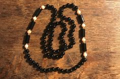 "This is a beautiful necklace!  It is approximately 8mm coral and black onyx round beads with 14k accent beads.  It is long and measures approximately 32\".  All beads are hand knotted on a black cord.  Excellent condition! A wonderful addition to any wardrobe.  Thank you for visiting Vintage Great Gets 💕" Elegant Hand-strung Black Beaded Necklace, Vintage Black Gemstone Beads Necklace, Elegant Hand-strung Onyx Necklaces, Elegant Onyx Hand-strung Necklaces, Elegant Hand-strung Onyx Necklace, Elegant Onyx Hand-strung Necklace, Elegant Hand-strung Black Necklace, Elegant Black Hand-strung Necklace, Vintage Black Beaded Necklace With Gemstone Beads