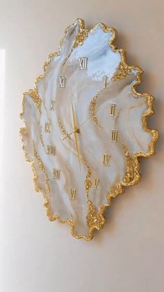 a clock made out of shell with roman numerals