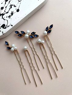 Introducing our exquisite elegant bridal hair pin set, a collection of 5 stunning pearl-adorned hair pins designed to elevate your wedding day or special occasion ensemble. Crafted from top-tier materials including crystal rhinestones, lustrous pearl beads, and silver-plated jewelry wire, these high-quality hair pins exude sophistication and timeless allure. Each blue hair pin is meticulously assembled to enhance your hairstyle with grace and elegance, ensuring a radiant and refined look. Custom Blue And Gold Hair Pins, Cheap Blue Hair Accessories For Gifts, Baby Blue Hair Pin, Navy Blue Hair Accessories, Blue Hair Pins, Navy Blue Hair, Bridal Hair Pins Pearl, Hair Pins Wedding, Hair Pins Bridal