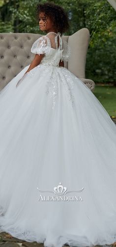 a woman in a white wedding dress sitting on a couch