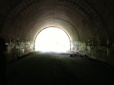 a dark tunnel with light at the end